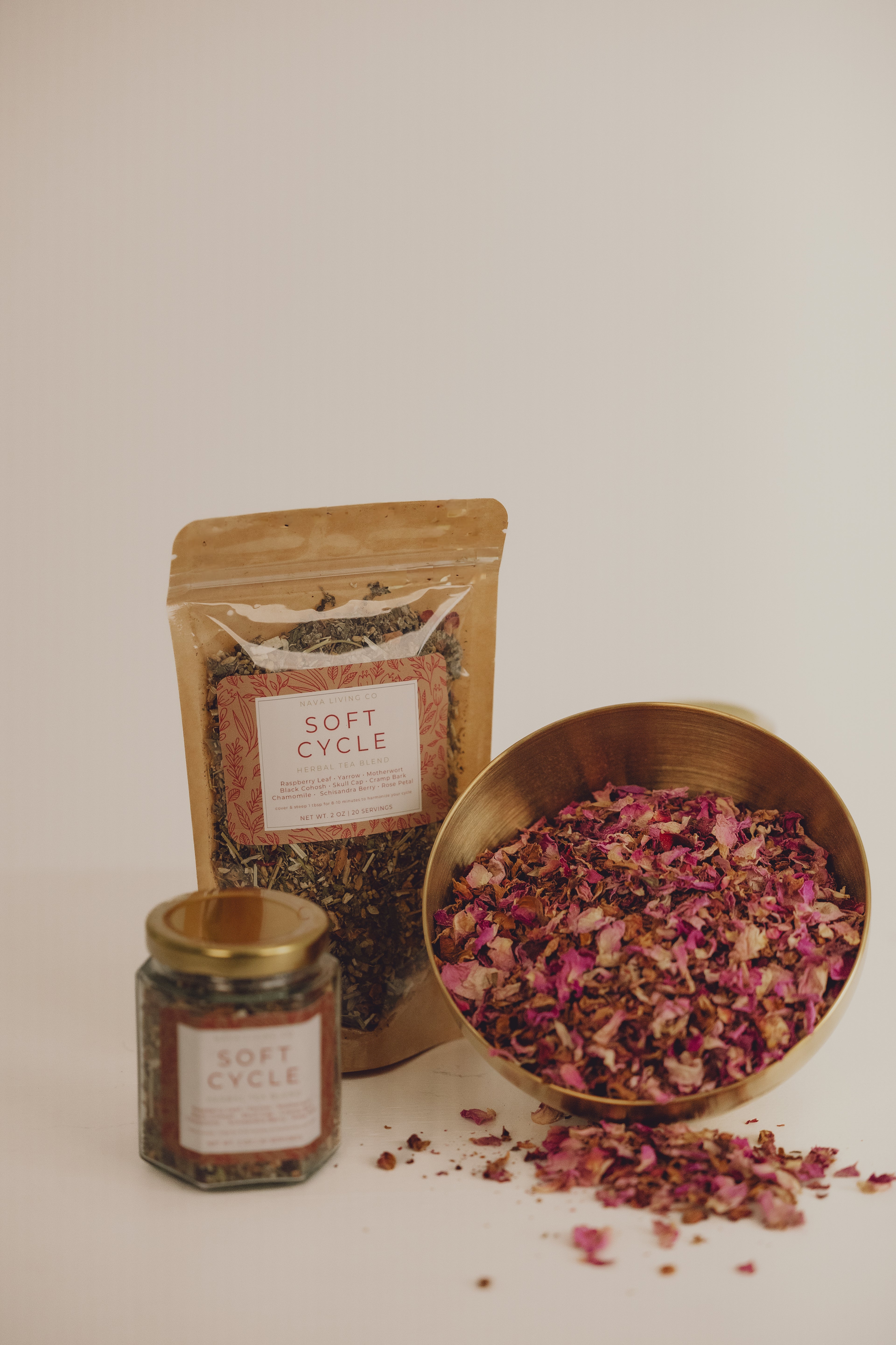Rose petals and a bowl with 'Soft Cycle' a tea blend for women branding on a white background